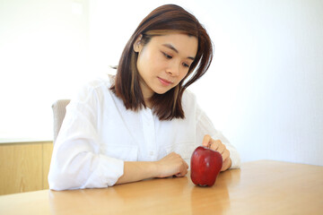 Obraz na płótnie Canvas woman watch the apple and thinking