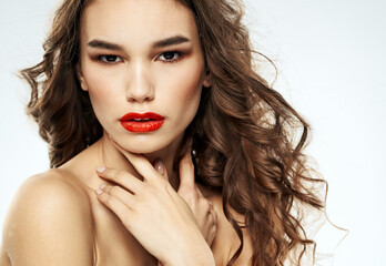 Fototapeta premium Woman brunette red lips shadows on eyelids portrait naked shoulders