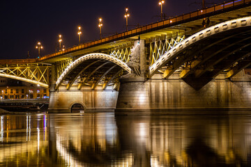 Night Budapest, Margit Bridge over the Danube River, reflection of night lights on the water