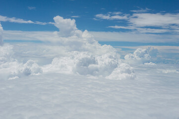 over the clouds,Blue sky with tiny clouds background Beautiful natural view from airplane window above. Background or Wallpaper.blue sky and cloud sky nature.Top view of aircraft