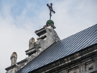 Fototapeta na wymiar LVIV, UKRAINE - March 2021: Exterior of The Bernardine church and monastery, today the Greek Catholic church of St. Andrew. Sculptures of monks on the roof.
