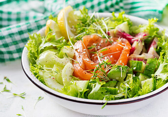 Ketogenic diet breakfast. Salt salmon salad with greens, cucumbers, celery and watermelon radish. Keto, paleo lunch.