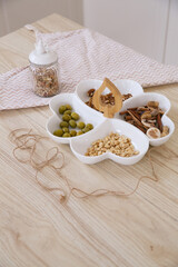 A festive plate served with nuts and other snacks in a bright Scandinavian kitchen
