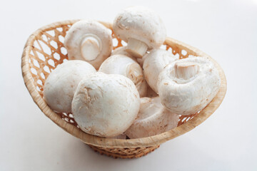 Mushrooms in a basket isolated on a white background