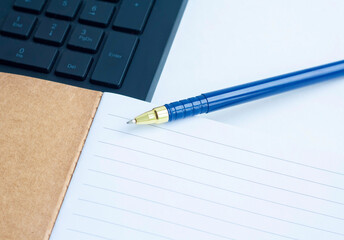 Planning, computer keyboard, notebook and blue pen, copy space