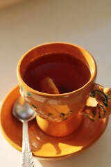 cup of black tea with lemon slice at early morning