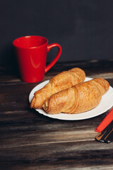 croissants on a white plate red mug kitchen appliances breakfast