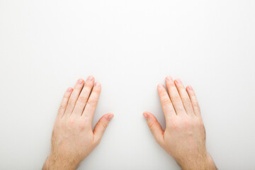 Young adult man hands on light gray table background. Closeup. Point of view shot. Top down view. © fotoduets