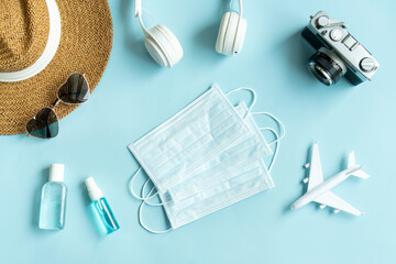 Flat lay of traveler accessories and medical item on blue color background. Travel, summer vacation and health care concept. Copy space for text, top view