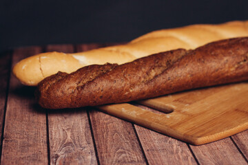 fresh crispy loaf cutting board knife wooden table flour product