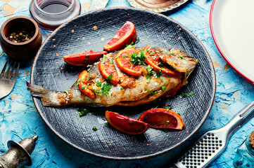 Baked dorada in orange sauce.