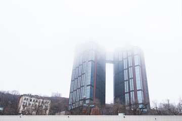 Modern multi-storey building in fog.