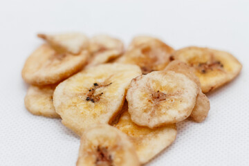 banana chips on white background close up