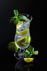 Mojito cocktail with ice, lime, and mint.