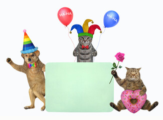 Pets clowns in holiday hats with balloons is near a green blank poster. White background. Isolated.