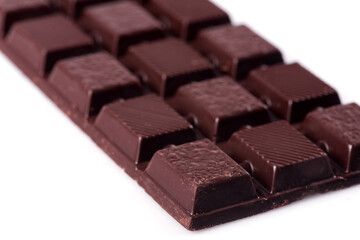 Broken dark chocolate broken stack isolated on white background