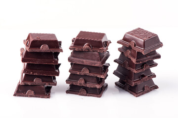 Broken dark chocolate broken stack isolated on white background