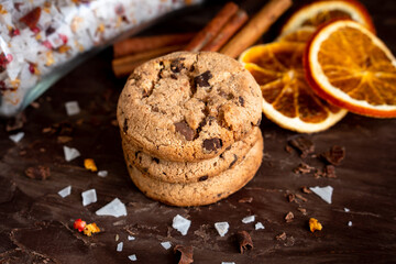 Organic food snack tasty sweet dessert milk dark chocolate chip salt cookie closeup piece fruit orange raspberry hazelnut nuts cinnamon on cocoa cacao powder wooden table for new year Christmas gift