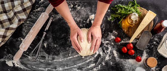 Woman kneading dough for pizza baking