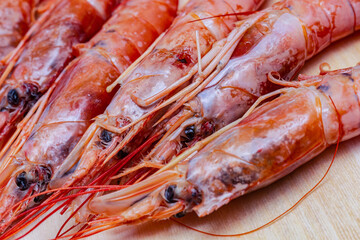 shrimp head pink base of broth and asia sauce on wooden background