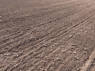 Arable land. Preparing field for planting. Plowed soil in spring time . Agricultural work.