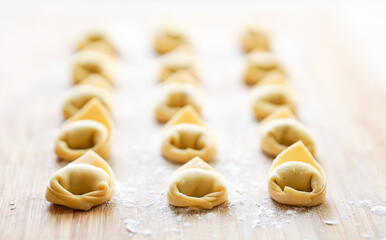 Fresh Tortellini pasta on a wooden board