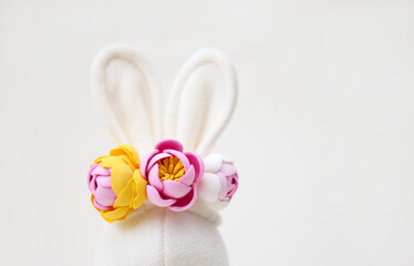 White rabbit ears with flowers, Easter card.