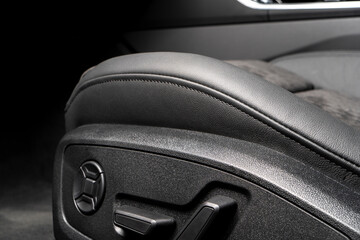 Modern luxury car black leather and alcantara interior. Part of black perforated leather car seat...