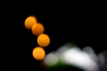 Take a close-up photo with blurred style, 4 lights Represents the light in the dark Isolated on black background.