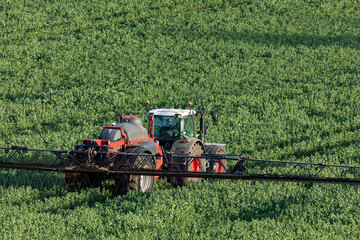 Agriculture - A farmer spraying fertilizer on his crops