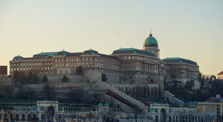 Fototapeta na wymiar Buda Castle lit by the setting sun in Budapest, Hungary