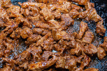 minced meat into pieces fried in a pan background culinary cooking