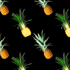 Seamless pattern of ripe pineapples isolated on black background. Top view. Exotic tropical fruit summer concept.