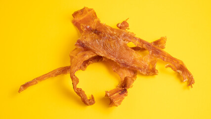 Meat chips. Dried meat set as a wine snack. Chicken jerky on yellow background. Dried chicken with...