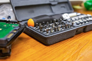 set of engineer tool set of nozzles for screwdriver and screwdriver stands on a table