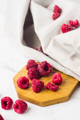 Freeze dried raspberry on wooden plate