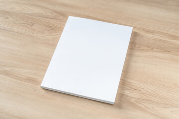 Book cover mockup with blank white front paper page a4 paperback mock up for catalog, magazine, menu, booklet, notebook, portfolio design template on wood table background