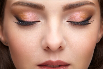 Naklejka premium Closeup portrait of female face with red lips and smoky eyes beauty makeup.