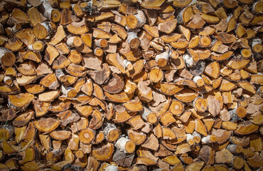 Chopped and stacked pile of pine and birch wood. Texture, background