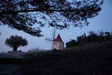 Fototapeta premium Mill of Daudet/Provence/France in the blue hour. Van Gogh has painted this motive. Today there are the new energies. Sustainability.