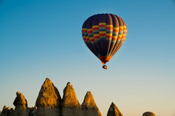 Hot air balloon flying over magnificent Cappadocia, Goreme, love valley at sunrise.