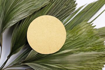 Blank paper on tropical palm dry leaves.