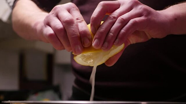 Close-up. Squeezing a fresh grapefruit juice with a hands