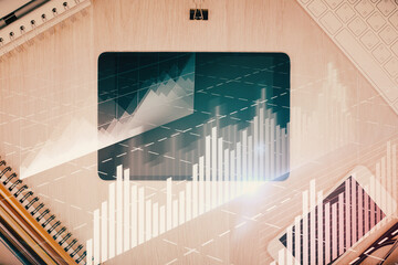 Double exposure of forex graph hologram over desktop with phone. Top view. Mobile trade platform concept.