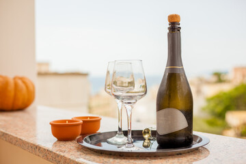 Tray with bottle of sparkling wine and crystal glasses