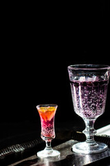Berry drink. Dark photography. Front of the glass in focus.