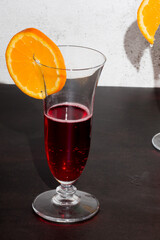 Red bitter. Non-alcoholic aperitif, served in a flute with a slice of orange
