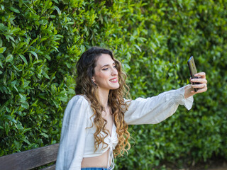 Mujer joven haciéndose un selfie en primavera 