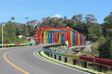 a colorful bridge that stretches over the river