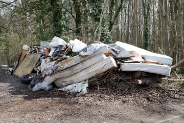 Fly-tipped illegal waste dumped beside rural road in Buckinghamshire, England, UK